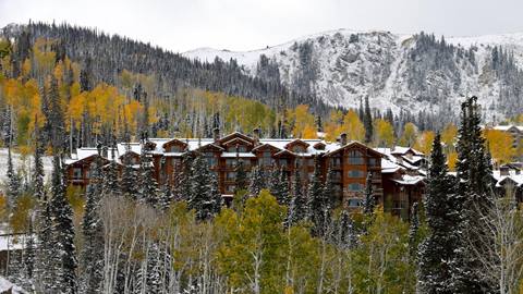 Grand Lodge exterior with yellow aspens and snow