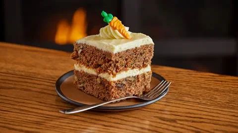 Deer Valley carrot cake sitting on wooden table.