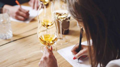 Students tasting sparkling wine during wine tasting class.
