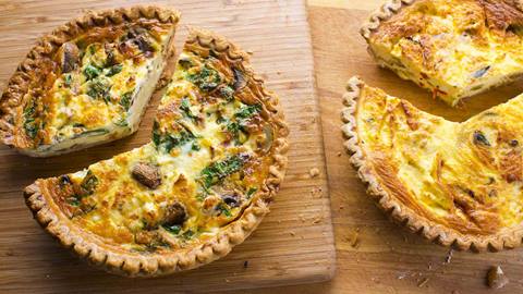 Two freshly made quiches.