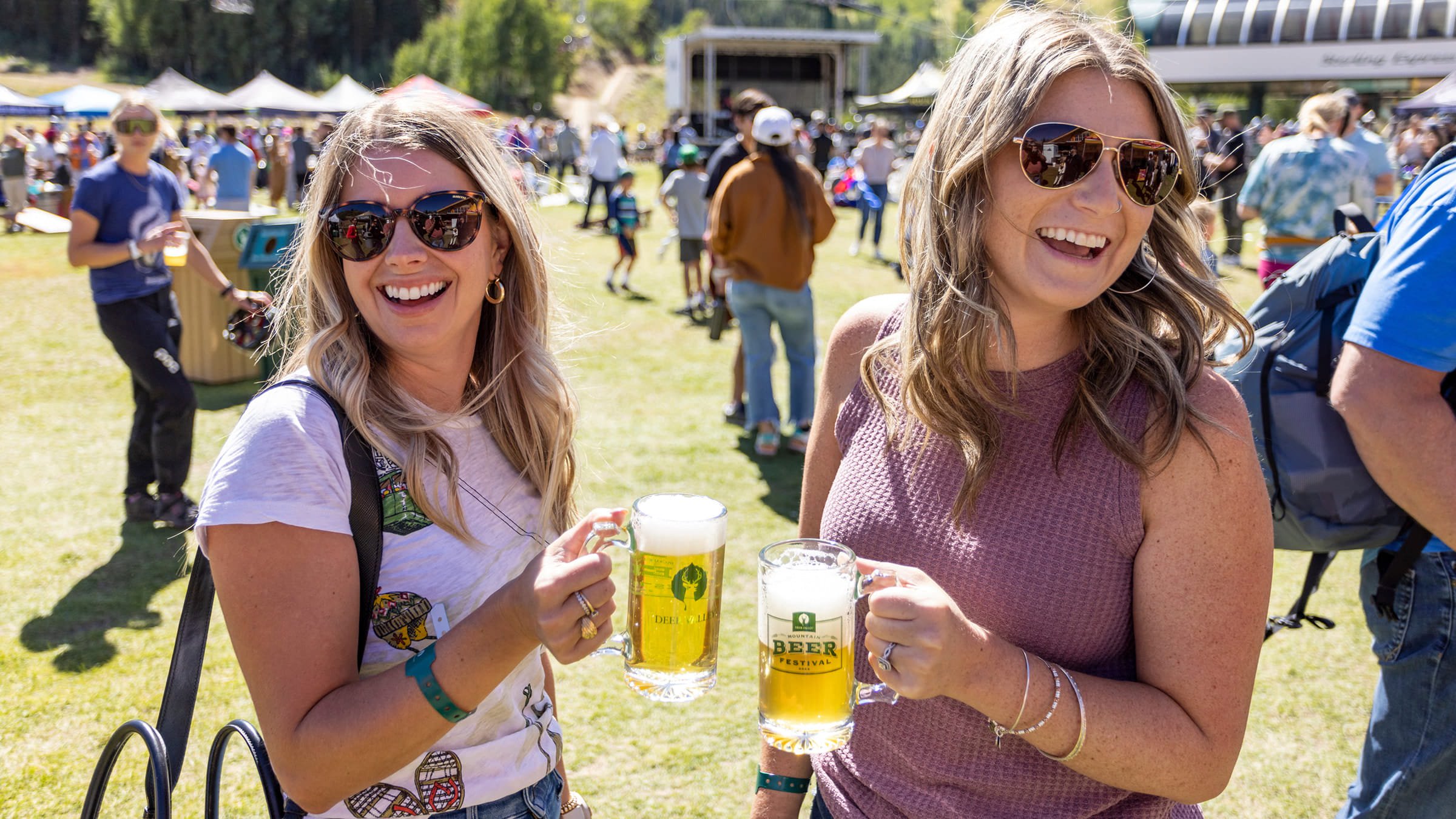 Two people drinking beer while laughing.