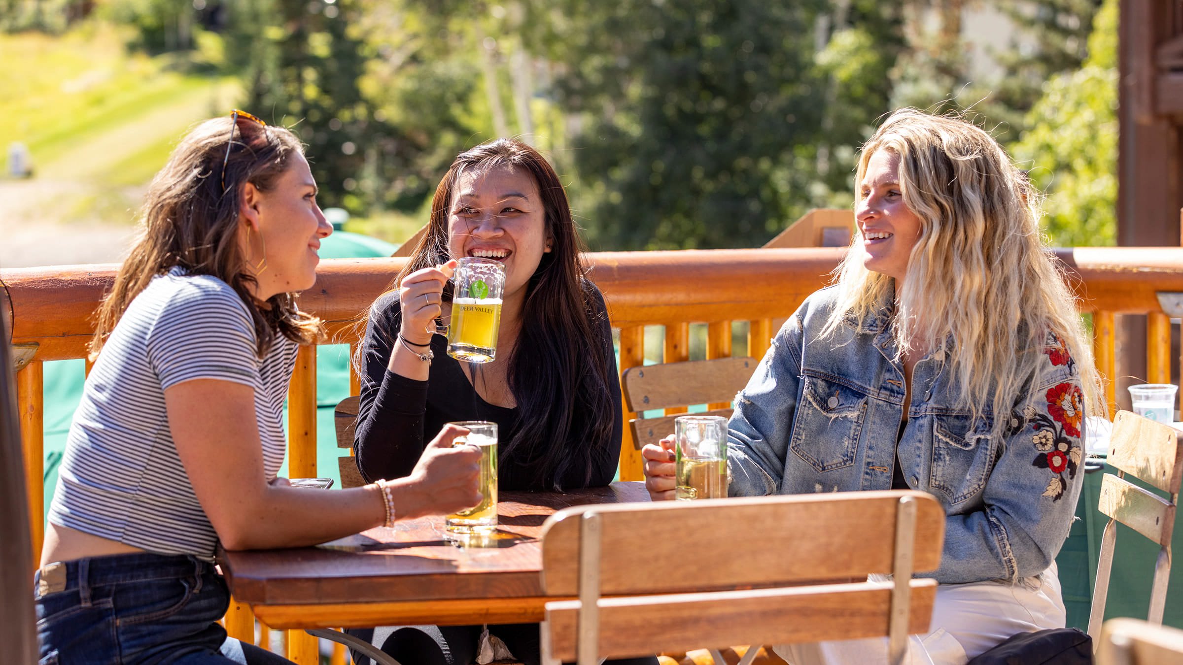 A group of friends drinking beer on the outdoor deck at Silver Lake Lodge.