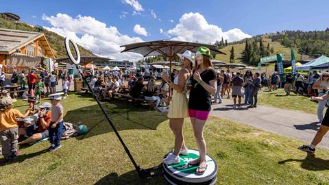 Two women using photobooth at Deer Valley Mountain Beer Festival in Park City, Utah.