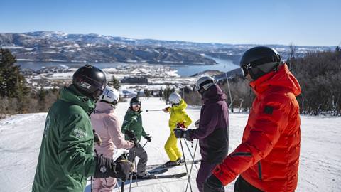Deer Valley Mountain Host Tour group standing on mountain looking at Mountain Host.