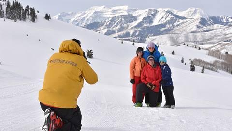A photographer taking a photo of a family