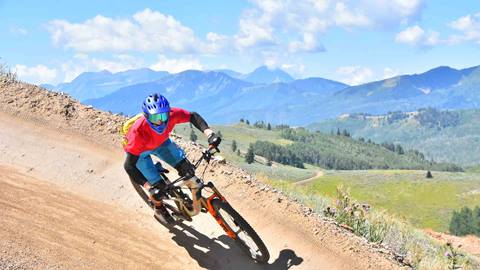 Mountain biker on trail with mountain views at Deer Valley Resort in Park City, Utah. Taken by Mountain Ridge Photography.