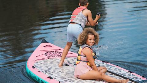 Kids stand up paddleboarding at Pebble Beach at Deer Valley.