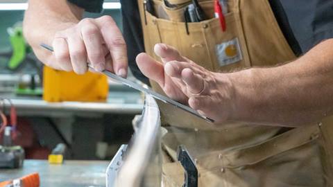 Tecnician working on a ski