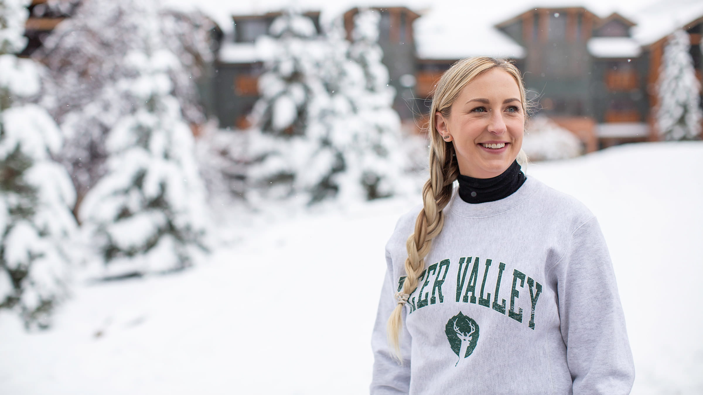 Woman smiling outside in snow.