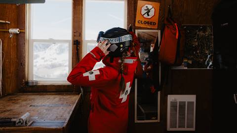 Deer Valley ski patroller putting on uniform.