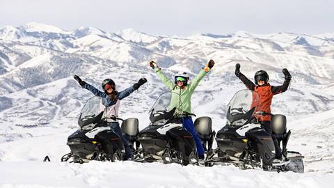Three women on Summit Meadows Adventures snowmobiling tour