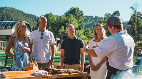 Guests watching chef giving a demonstration during a cooking class at Deer Valley.