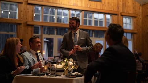 Deer Valley staff member welcomes guests to fine dining experience.