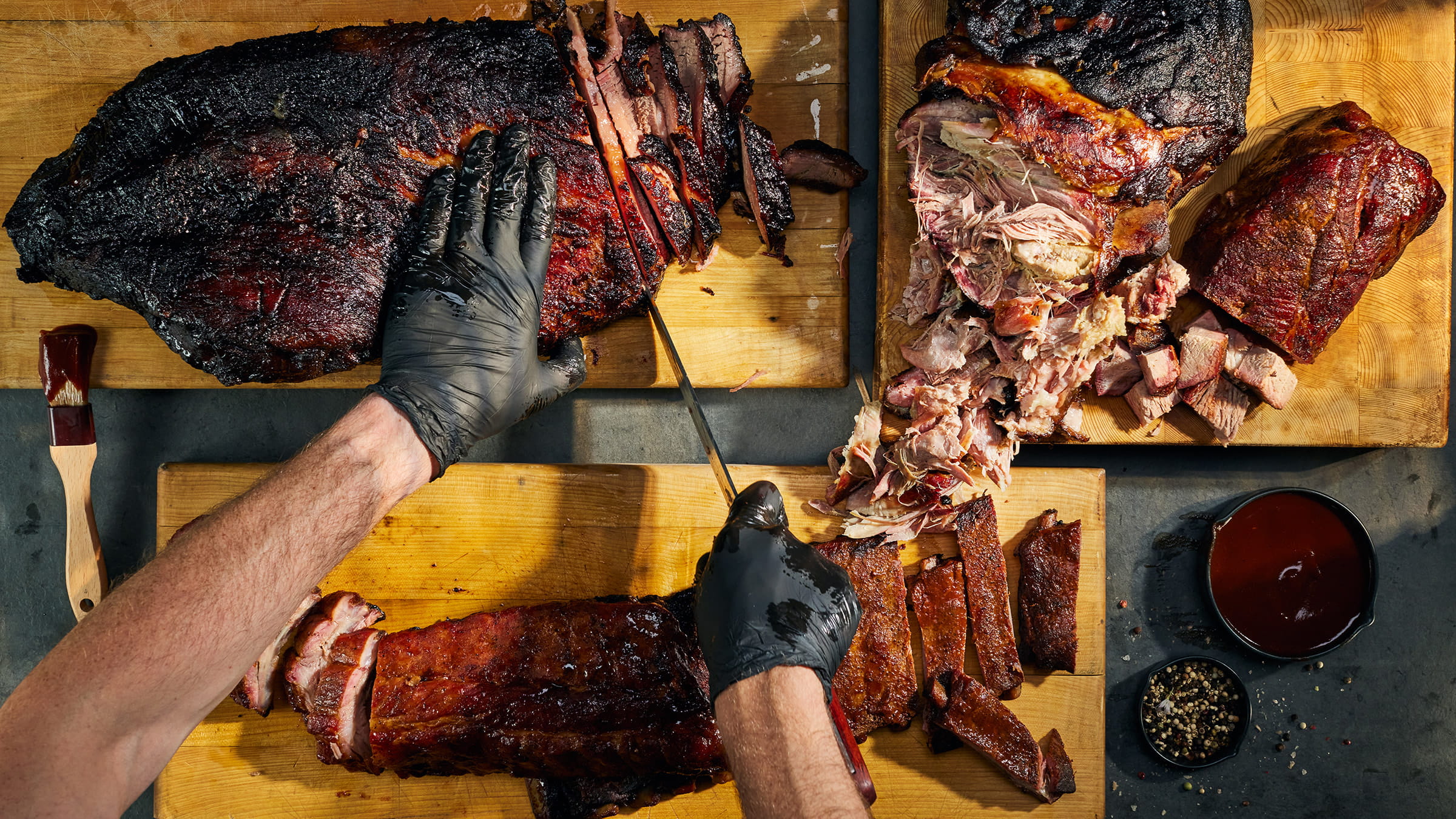 Chef cutting smoked meats.