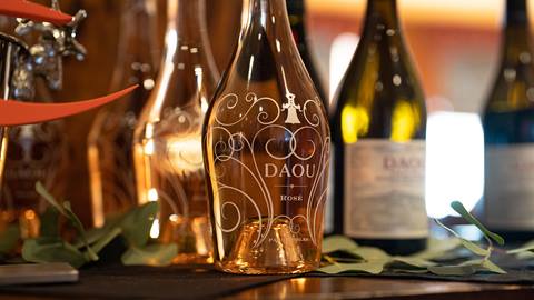 DAOU wine bottles displayed at Taste of Luxury event.