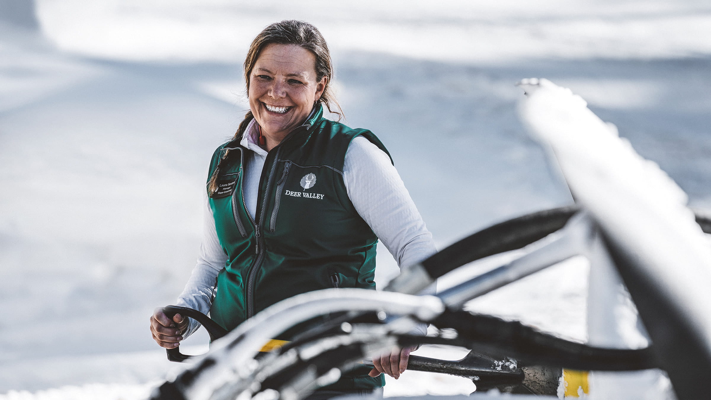 Deer Valley Grooming Manager, Laura Sexton, standing outside of a snow cat smiling.