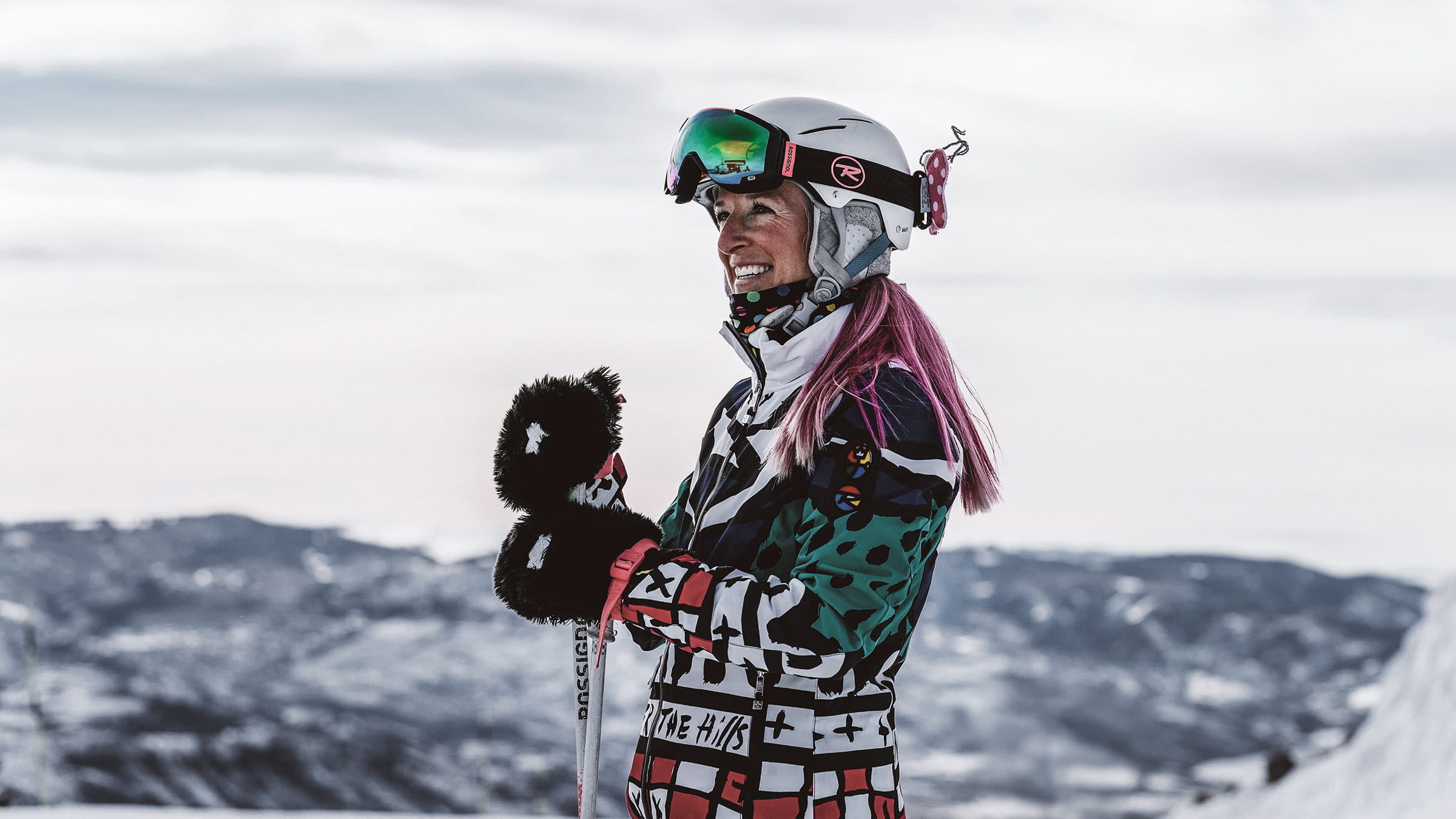 Shannon Bahrke looking away from the camera smiling in her ski gear.
