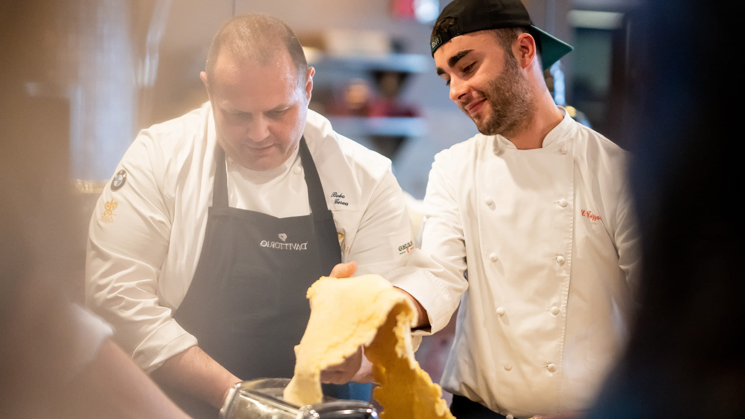 Chef Cerea instructing another chef in the art of making pasta.