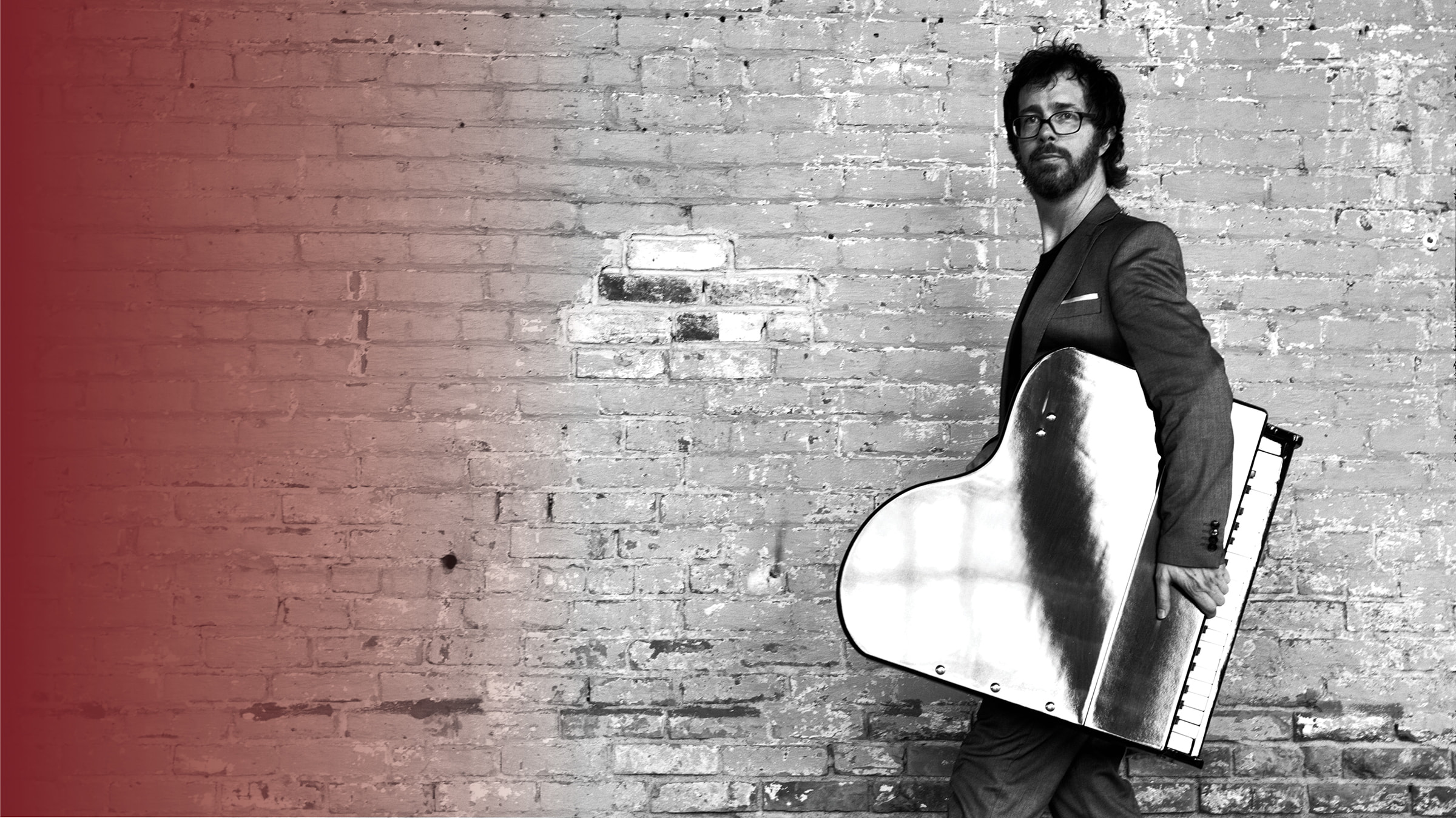 Musician, Ben Folds, carrying baby grand piano