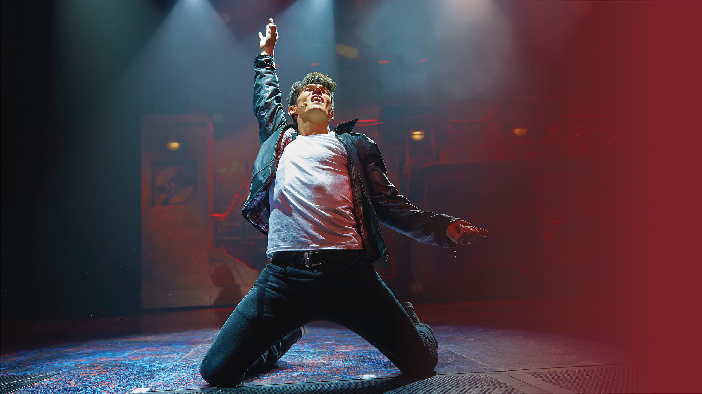 Man sliding on his knees while on stage in a rock concert