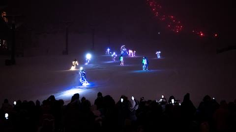 People participating in the torchlight parade at Deer Valley Resort.
