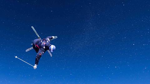 Athlete Nick Page doing a trick on skis.