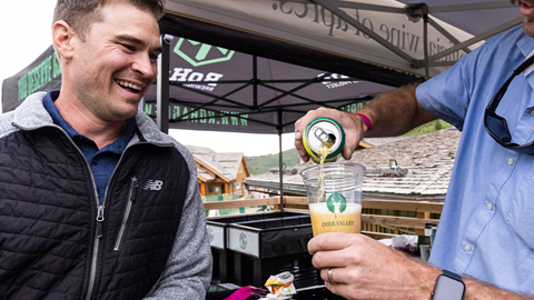 Staff serving guest a beer during a summer event at Deer Valley Resort.