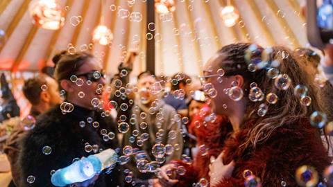 Guests dancing with bubbles inside Deer Valley's après-ski yurt, Chute Eleven.
