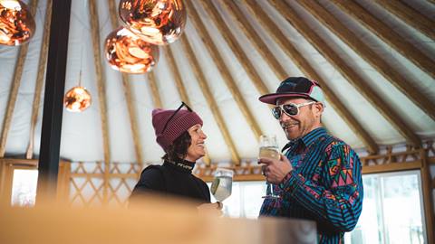 Couple drinking cocktails inside Deer Valley's après-ski yurt, Chute Eleven.