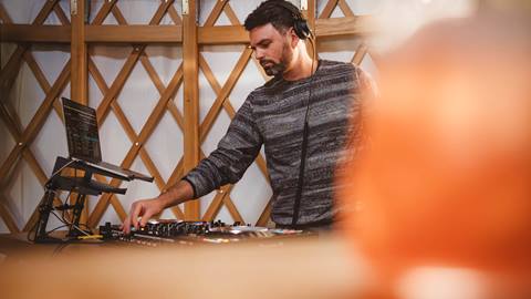 Male DJ performing at Chute Eleven in Deer Valley.