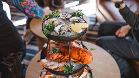 Guests enjoying seafood tower inside Deer Valley's après-ski yurt, Chute Eleven.