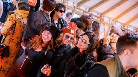Three women smiling inside Chute Eleven at Deer Valley
