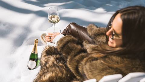 Woman drinking champagne outside Deer Valley's après-ski yurt, Chute Eleven.