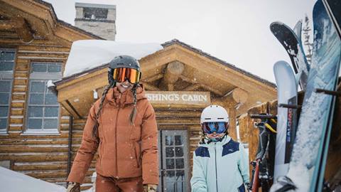 Mother and daughter in ski gear outside Cushing's Cabin at Deer Valley.