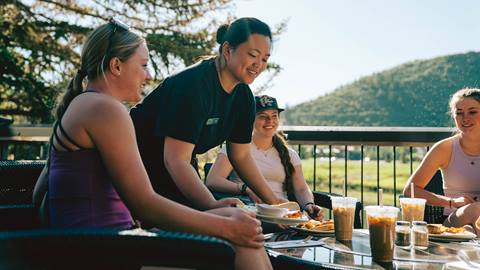 Friends having coffee and breakfast on the deck at Deer Valley Café.
