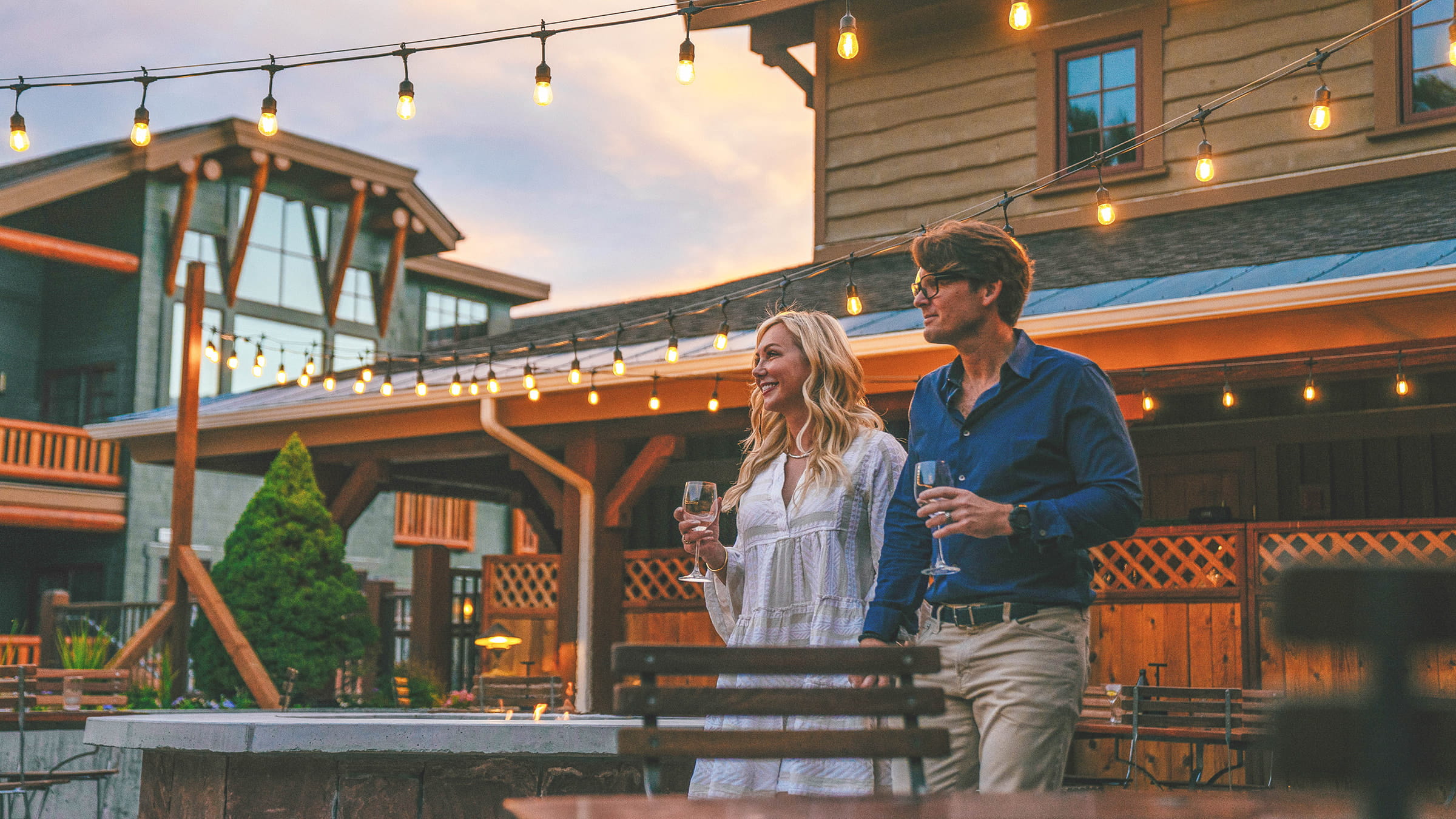 Couple holding hands while drinking wine on the Brass Tag deck.