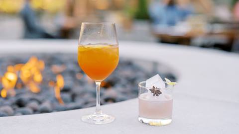 Specialty cocktails by the firepit at The Brass Tag in the summer.