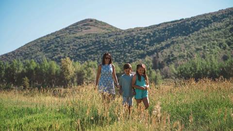 Mom and two kids hiking at Deer Valley Resort in Park City, Utah.