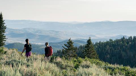 Two guests hiking at Deer Valley in the summer.
