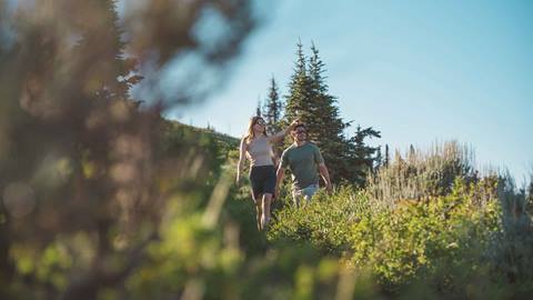 Couple hiking at Deer Valley Resort in Park City, Utah.