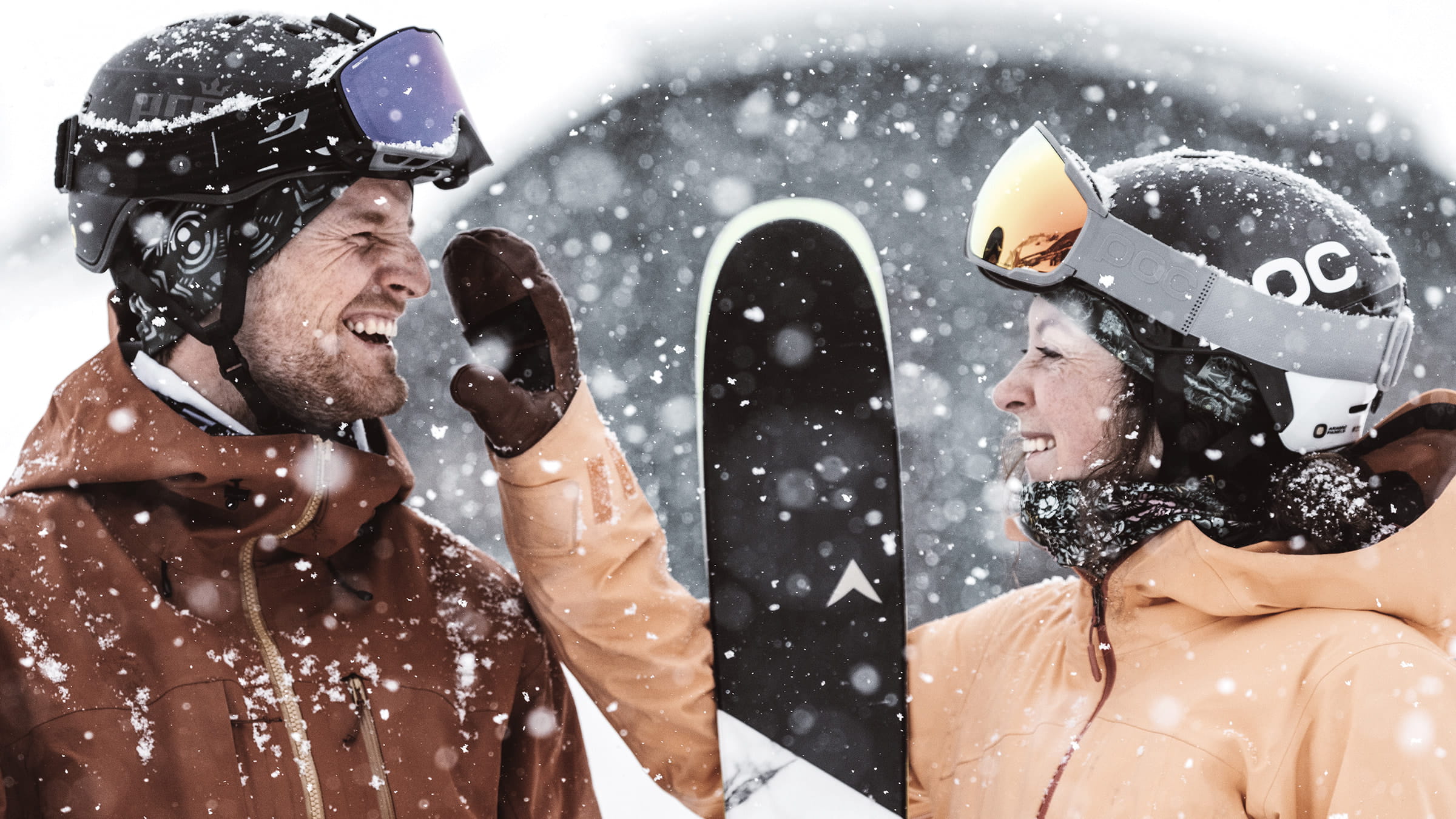 Couple smiling outside in the snow.