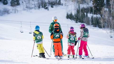 Ski instructor teaching kids ski lesson at Deer Valley Resort.