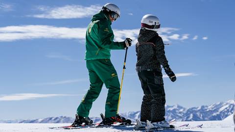 Deer Valley ski instructor teaching young girl in a ski lesson.