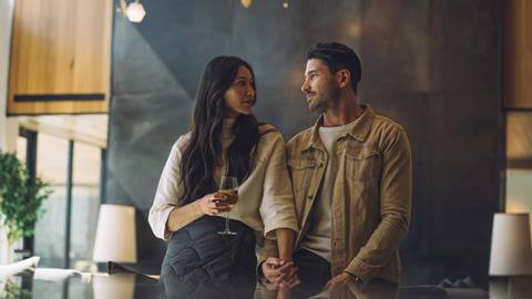 Couple holding hands in luxury lodging property at Deer Valley.