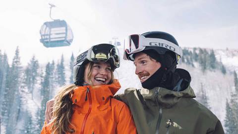 Young couple smiling at each other on Deer Valley gondola.