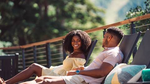 Couple sitting at the pool at Stag Lodge in the summer.