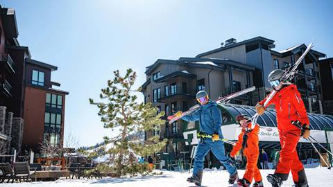 Deer Valley lodging guests leaving ski-in/ski-out property with skis.