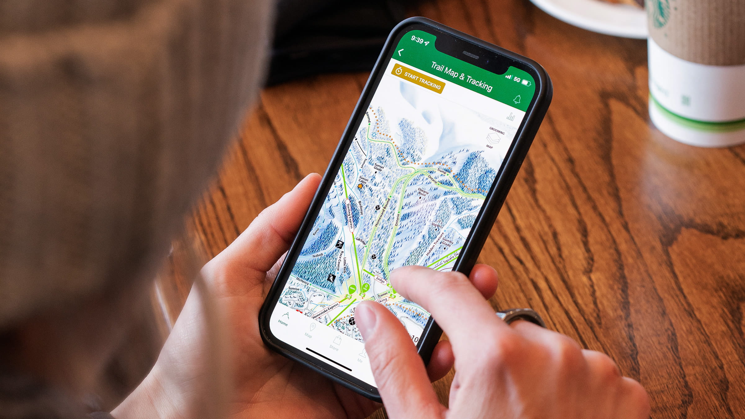 Woman viewing interactive trail map on the Deer Valley app.