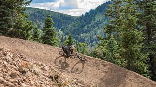 Man mountain biking at Deer Valley with a beautiful view.