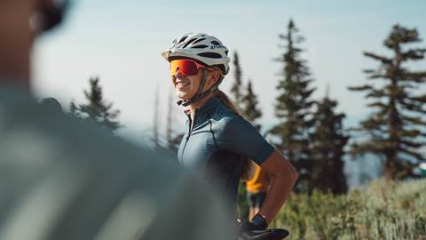 Female mountain biker standing on trail at Deer Valley.